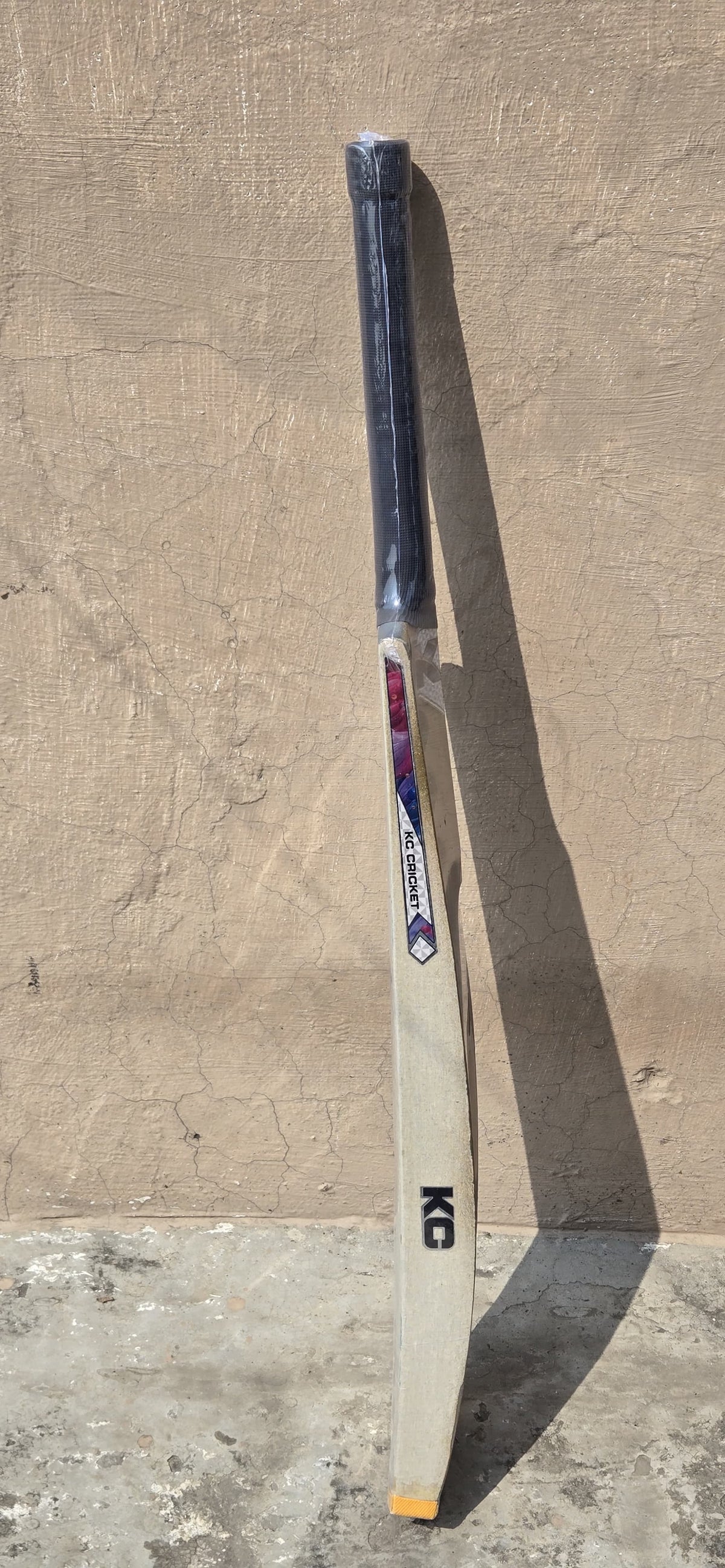 Close-up product view of the KC gold scoop cricket bat